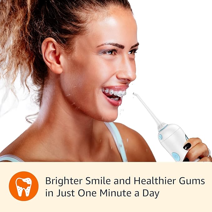 Amazon Basics HydroClean Portable Cordless Water Flosser for Teeth and Gums 2 Pressure Tips Removable Tank 30 Seconds Water Capacity 2 AA Batteries Included
